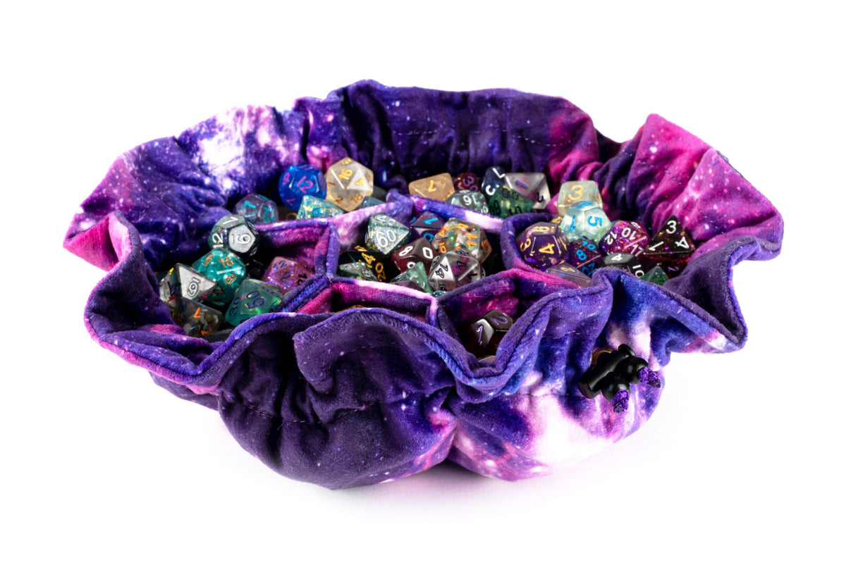 FanRoll velvet compartment dice bag in nebula print, open with dice sets in each separated pocket